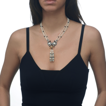 model wearing yellow gold, silver, pearl and diamond necklace with detachable tassel